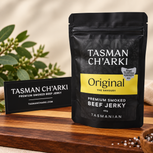 Tasman Charki Original premium smoked Tasmanian beef jerky pouch displayed on a wooden board.